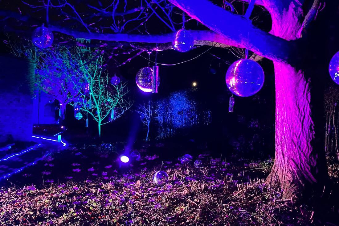 Lit up tree with disco balls glowing