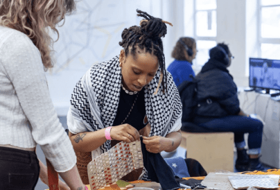 Black Creative doing some weaving in a workshop